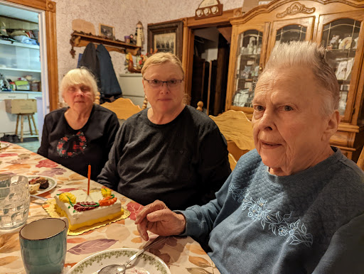 A family gathering to celebrate a birthday with cake and smiles.