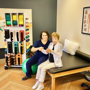 A therapist and patient engaging in a physical therapy session in a clinic.