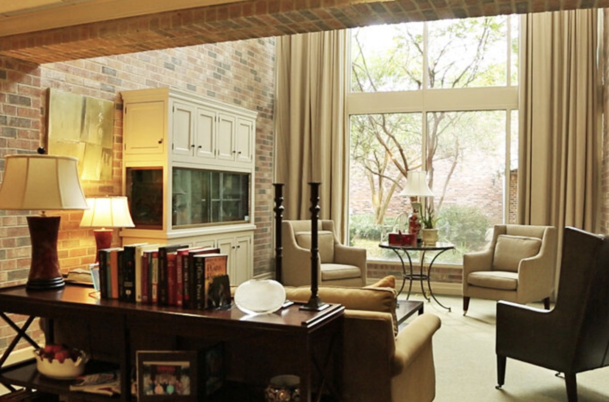 A cozy and modern living room with large windows and elegant furniture.