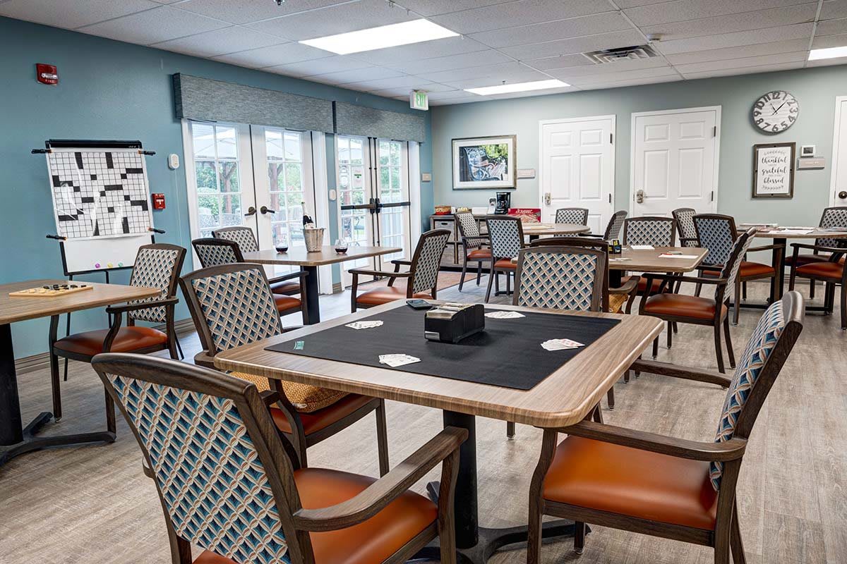 A community dining area with tables and chairs arranged neatly.