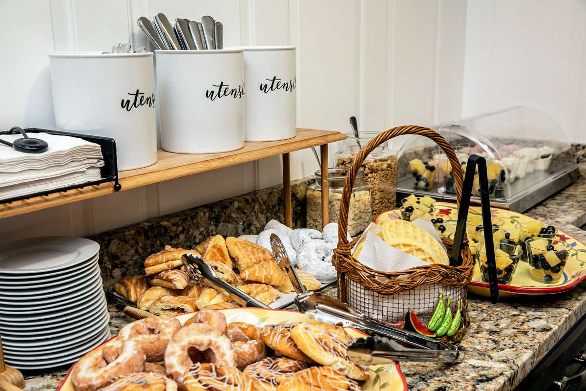 A delicious assortment of pastries and bakery items set up for a breakfast buffet.
