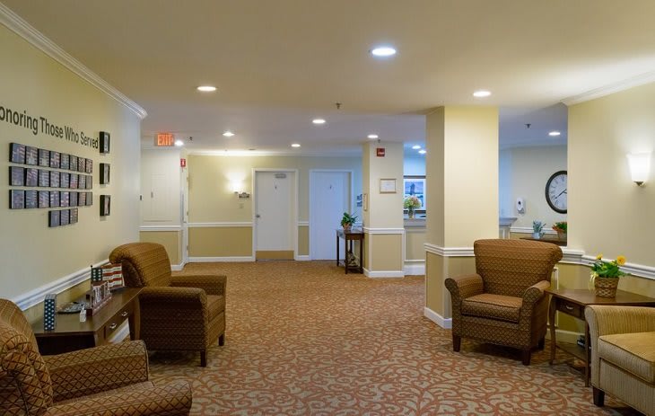 A cozy lobby area featuring comfortable chairs and warm lighting.