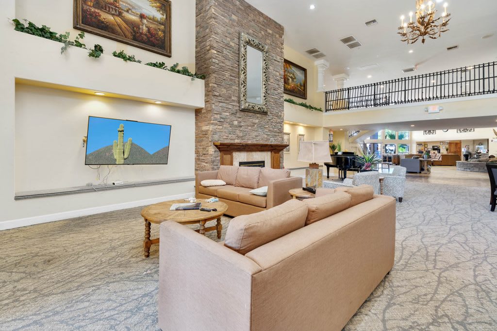 A modern and luxurious living room with comfortable seating, a fireplace, and elegant interior design.