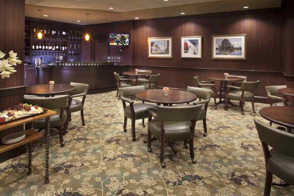 A cozy restaurant dining area with elegant furnishings and a fully stocked bar.
