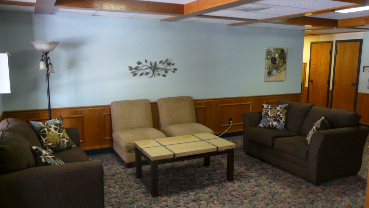 A cozy living room with comfortable seating and decorative wall art.