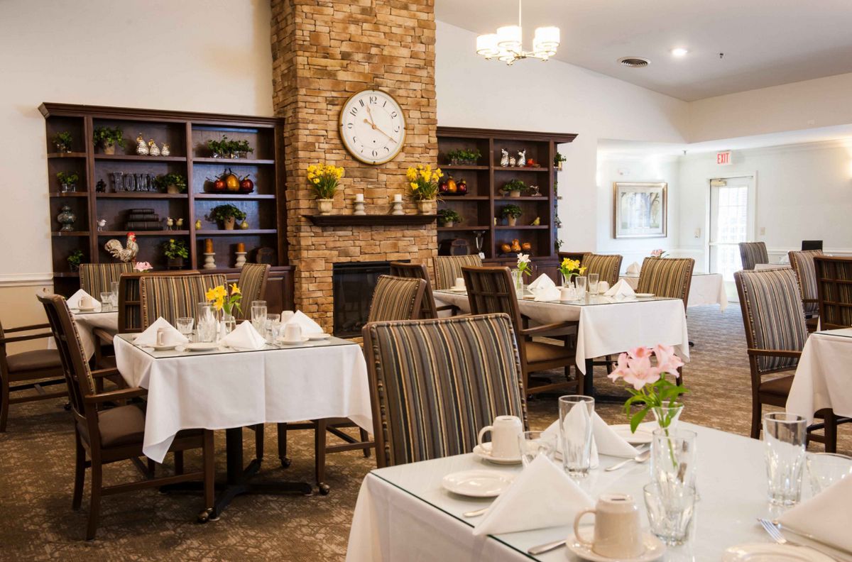 A cozy restaurant dining area with elegantly set tables and a warm, inviting decor.