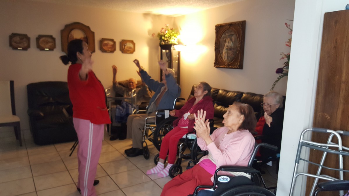 A group of elderly people participating in a lively indoor activity.