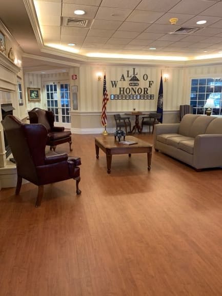 A cozy lobby area with comfortable seating and a Wall of Honor display.