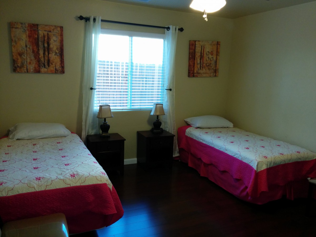 A cozy bedroom with twin beds and tasteful decor.