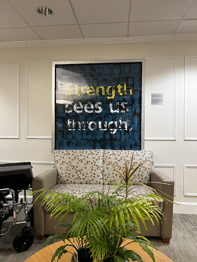 A cozy living space featuring inspirational artwork that reads 'Strength Lies Within.'