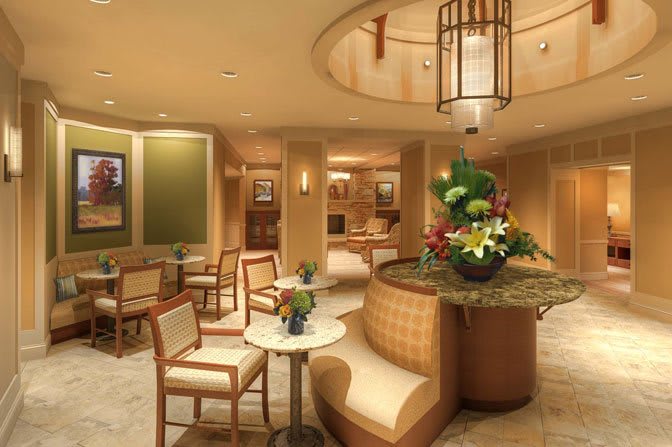 A modern lobby with elegant seating and a vibrant flower arrangement.