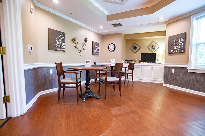 A cozy dining area with wooden flooring and elegant furniture.