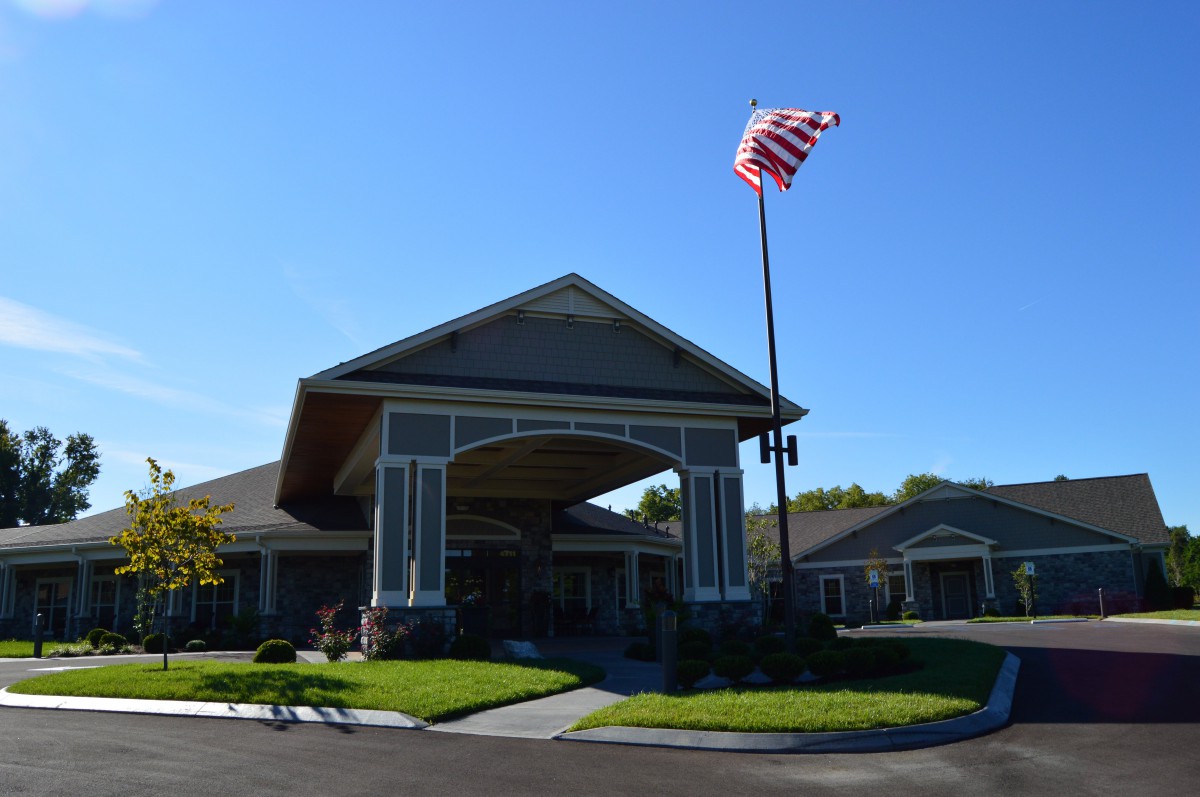 A building with an American flag flying on a clear, sunny day.