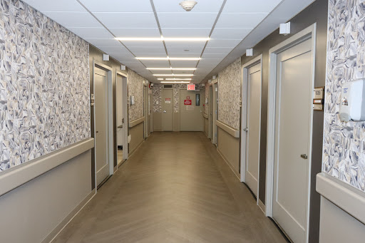 A view of a modern hallway featuring multiple doors and decorative wall patterns.