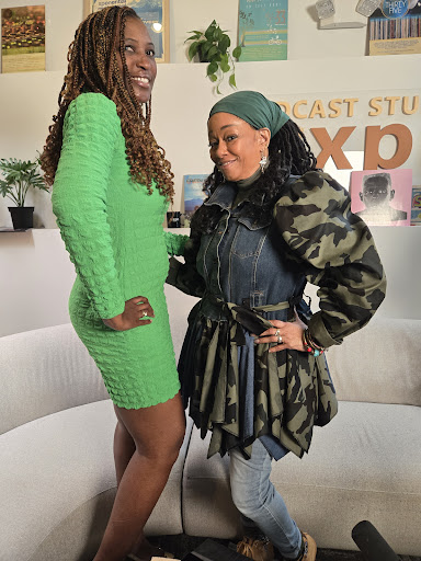Two stylish women showcasing their unique fashion choices in a studio setting.
