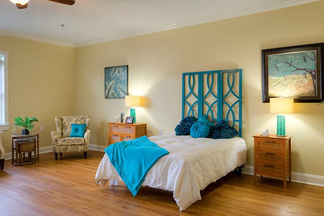 A cozy bedroom with turquoise accents and wooden furniture.