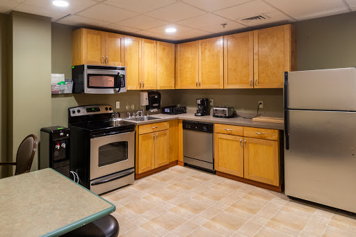 A well-equipped kitchen featuring wooden cabinets and modern appliances.