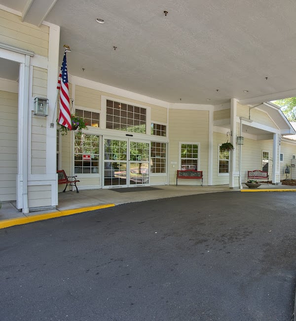A porch entrance of a building featuring an American flag.