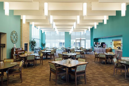 A spacious and modern dining area with tables and chairs designed for a comfortable dining experience.
