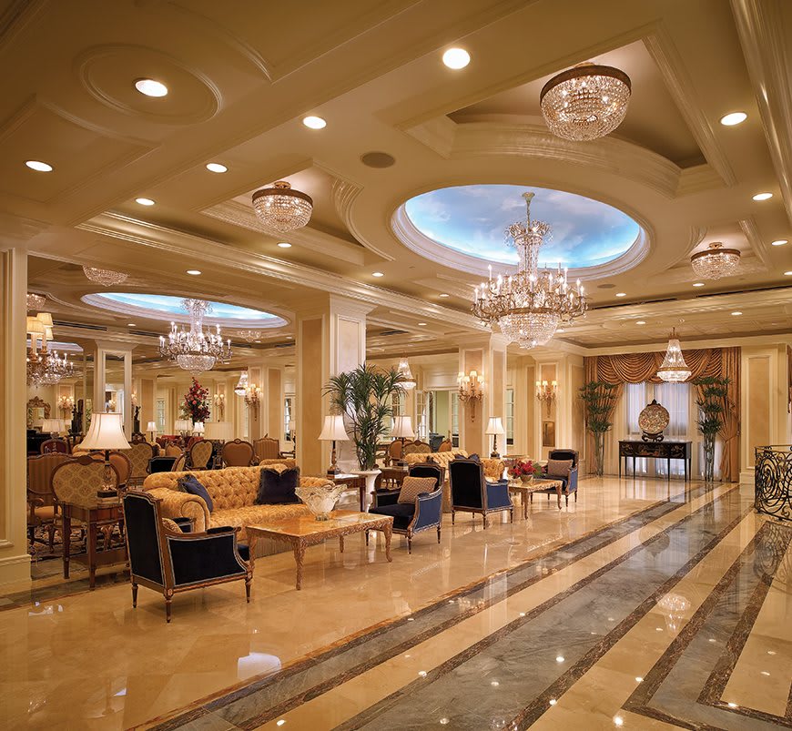 A luxurious hotel lobby featuring elegant chandeliers and comfortable seating areas.