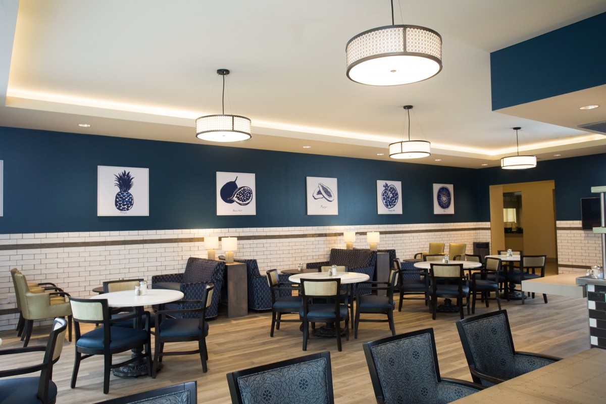 A modern restaurant interior with stylish seating and artwork on the walls.
