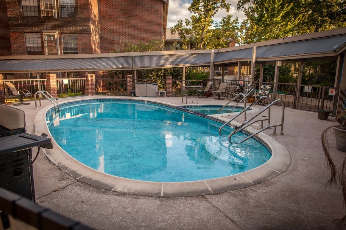 An outdoor swimming pool located in a residential apartment complex.