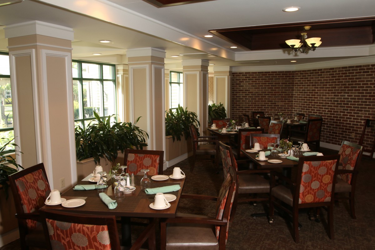 An elegant restaurant dining area with neatly arranged tables and chairs.