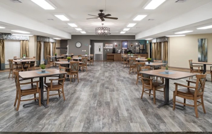 An empty dining area with modern decor and neatly arranged tables and chairs.
