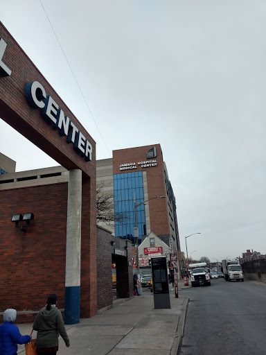 A view of a commercial center on a cloudy day, showcasing modern architecture.