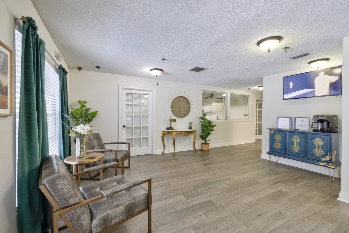 A modern and welcoming lobby area featuring comfortable seating, decorative plants, and a reception desk.