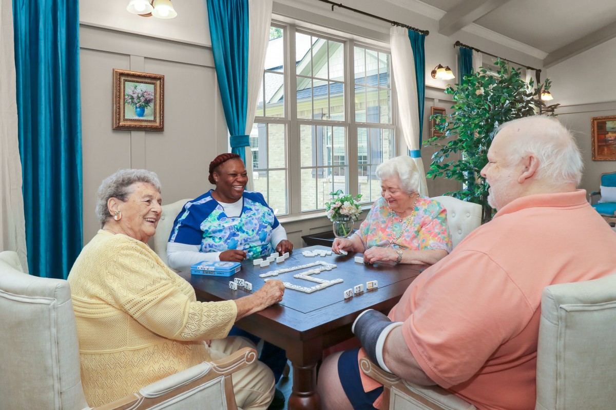 A group of seniors enjoying a card game in a nursing home.