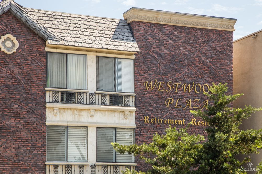Exterior view of the Westwood Plaza Retirement Home with visible signage and windows.