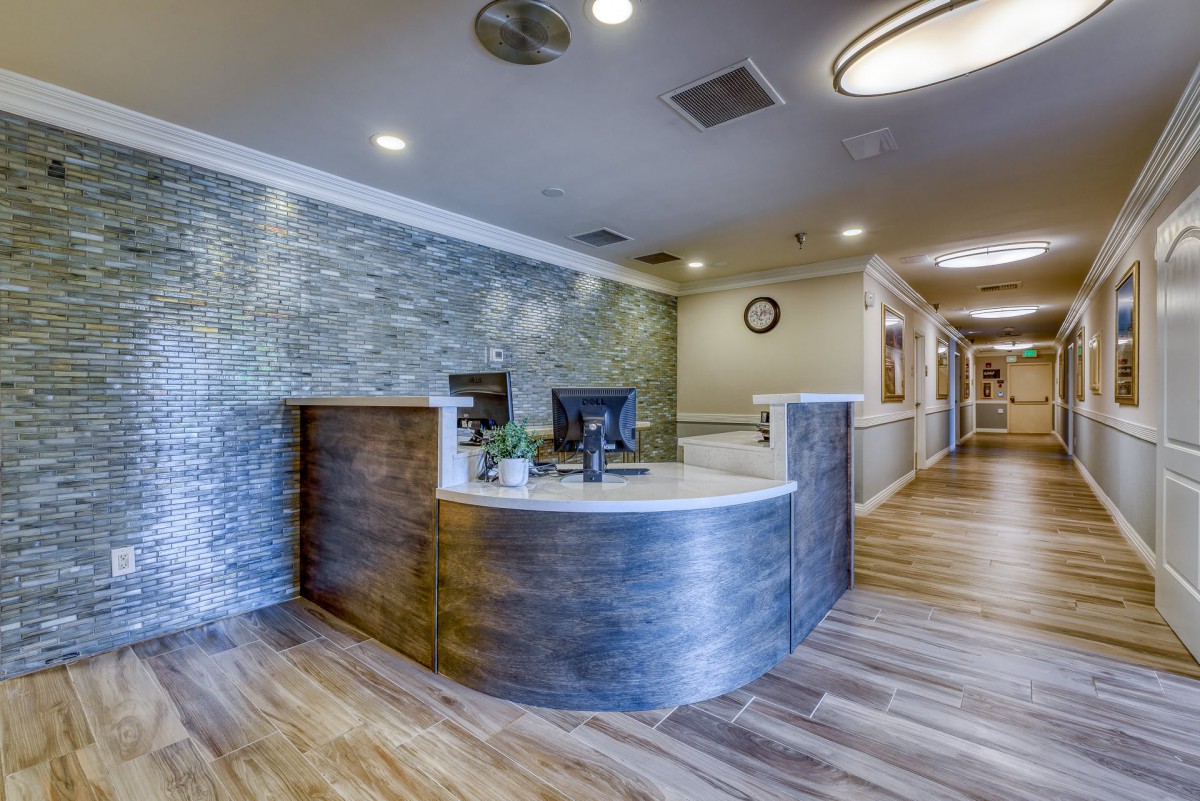 A modern reception desk in a well-lit office hallway.