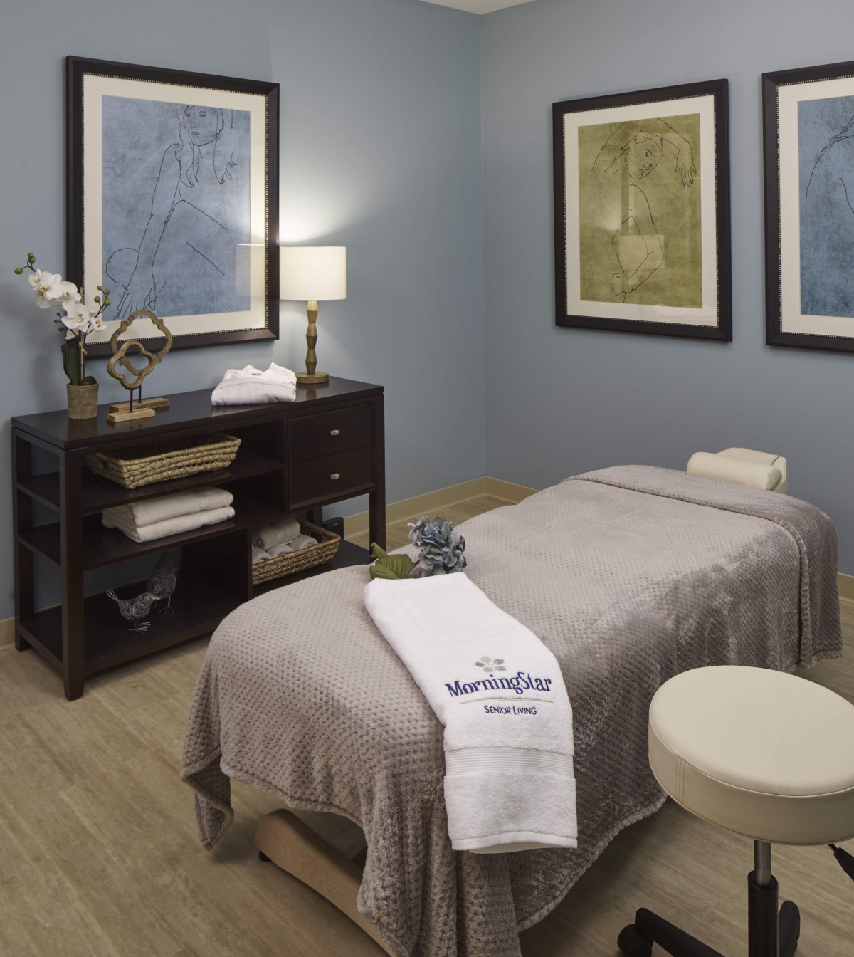A serene massage room with calming decor and a comfortable therapy bed.
