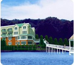 A scenic view of a building by the water with a bridge leading to it.