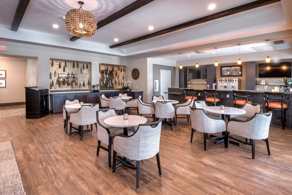 A modern restaurant interior with a cozy dining area and bar.
