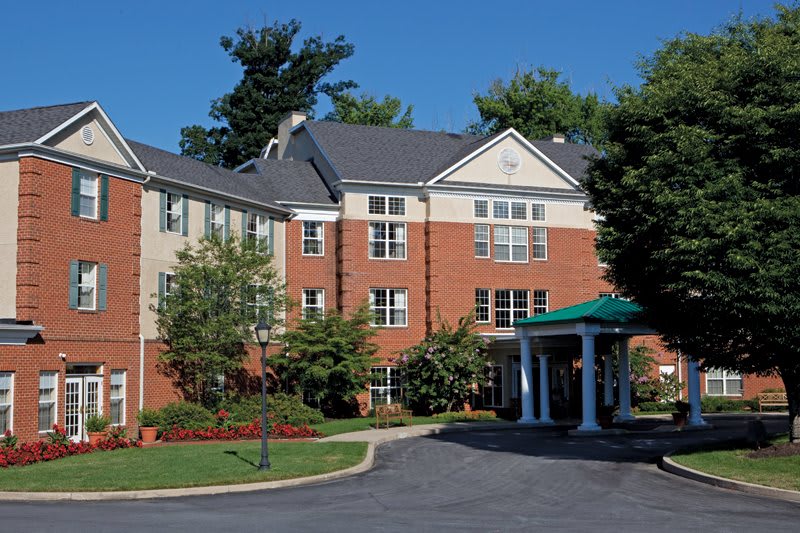 A residential building with landscaped grounds and a covered entrance.