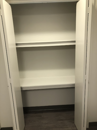 An empty storage cabinet with three shelves.