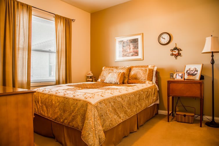 A cozy bedroom with warm-toned decor and a neatly made bed.