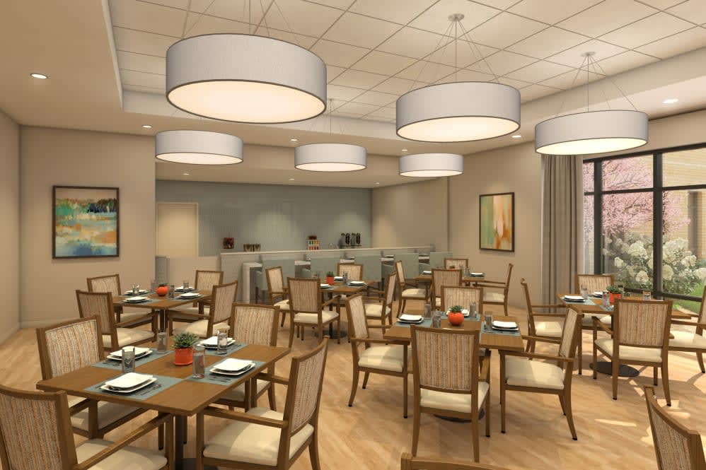 A modern restaurant dining area with neatly arranged tables and chairs, featuring stylish lighting fixtures.