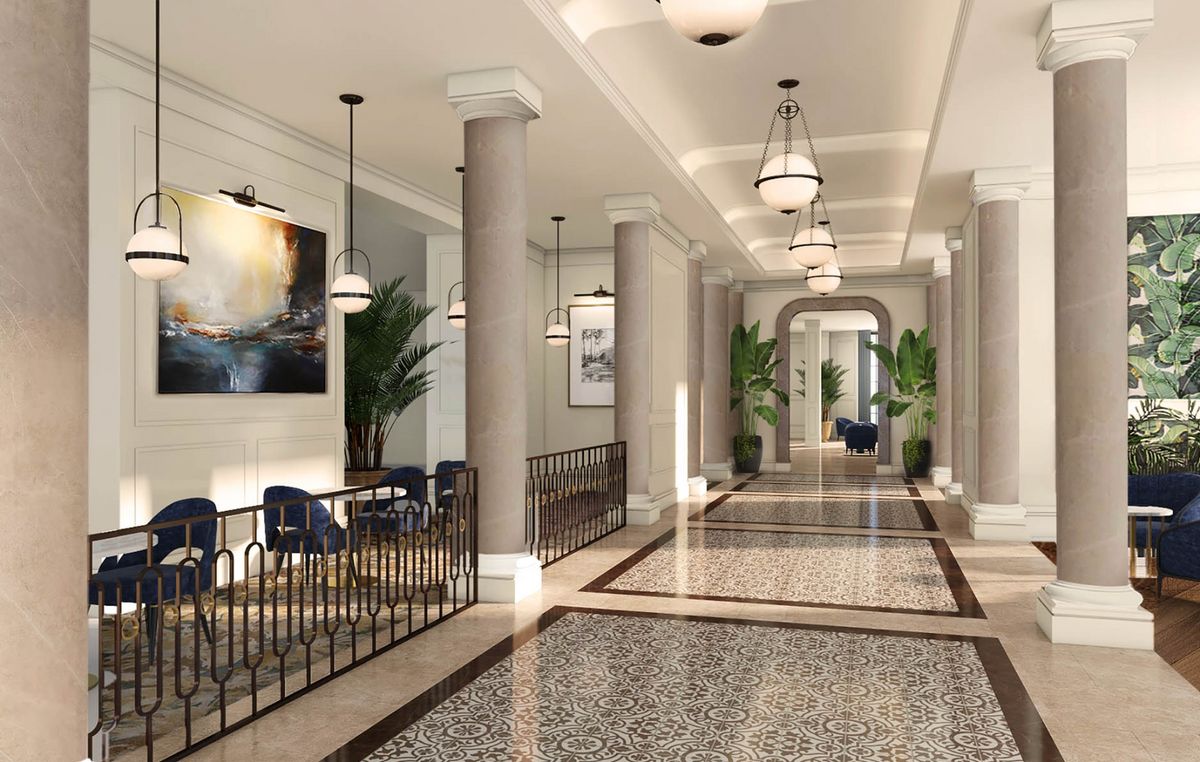 A luxurious, modern hallway with chandeliers, columns, and a stylish seating area.