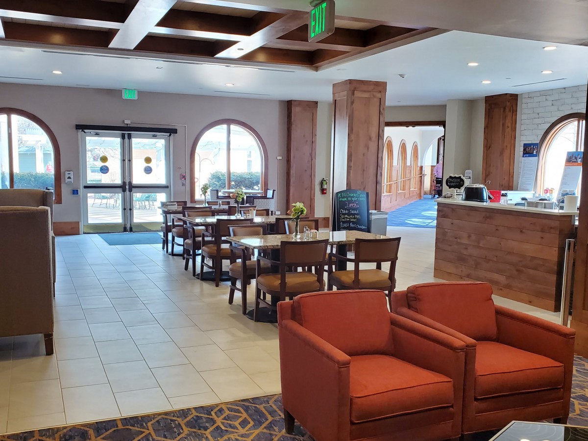 A spacious lobby with seating area and reception desk.