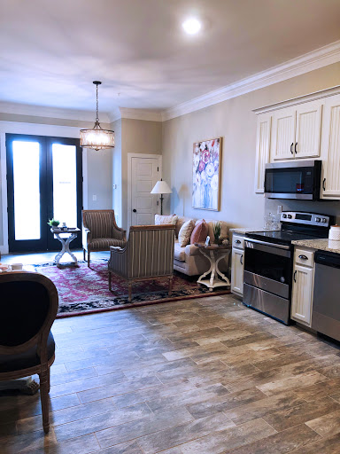 A beautifully designed open-concept living area featuring a cozy seating arrangement and modern kitchen amenities.