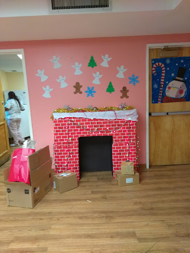A festive holiday-themed corner featuring a decorated fireplace and cheerful wall art.