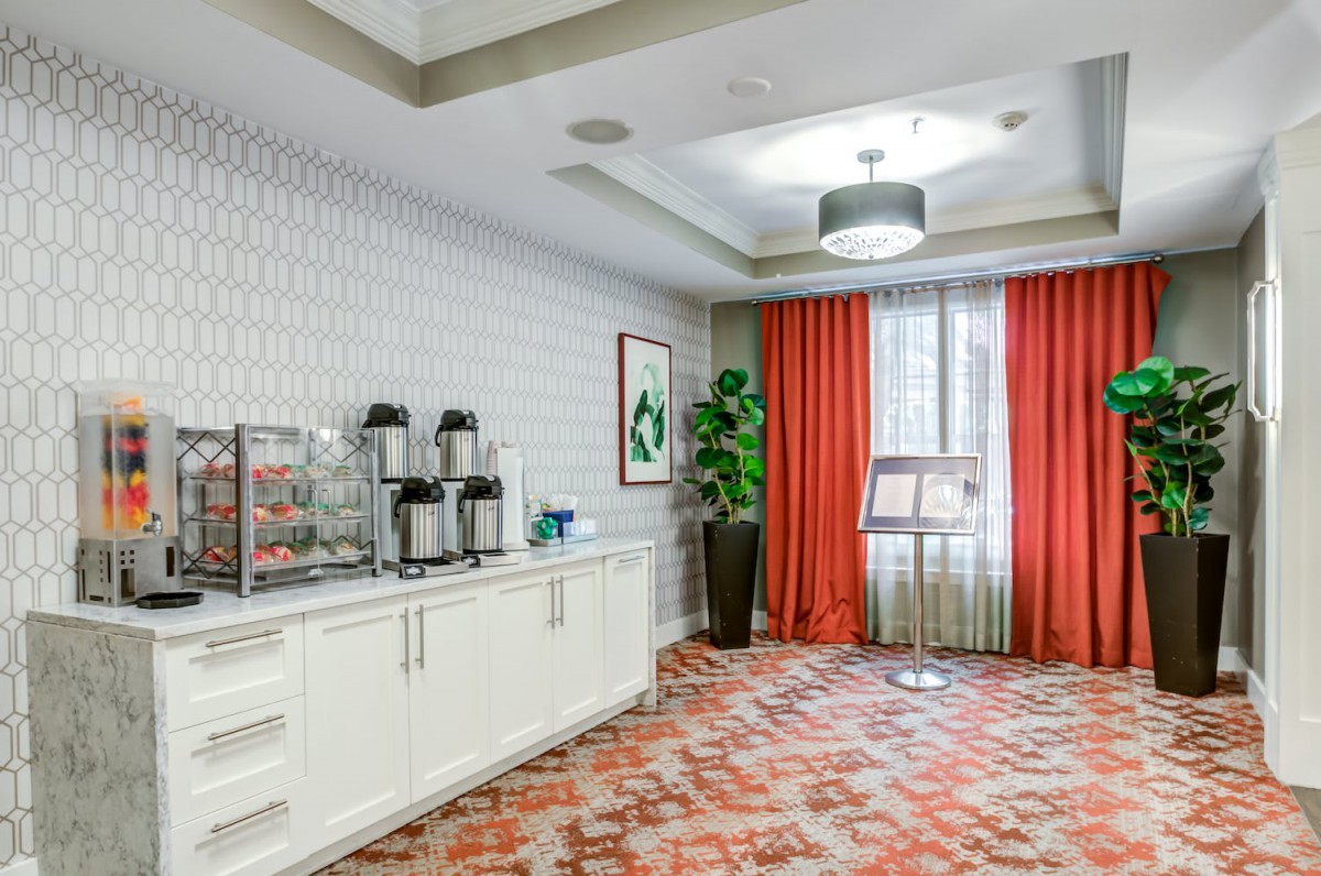 A modern conference room with a coffee station and vibrant decor.