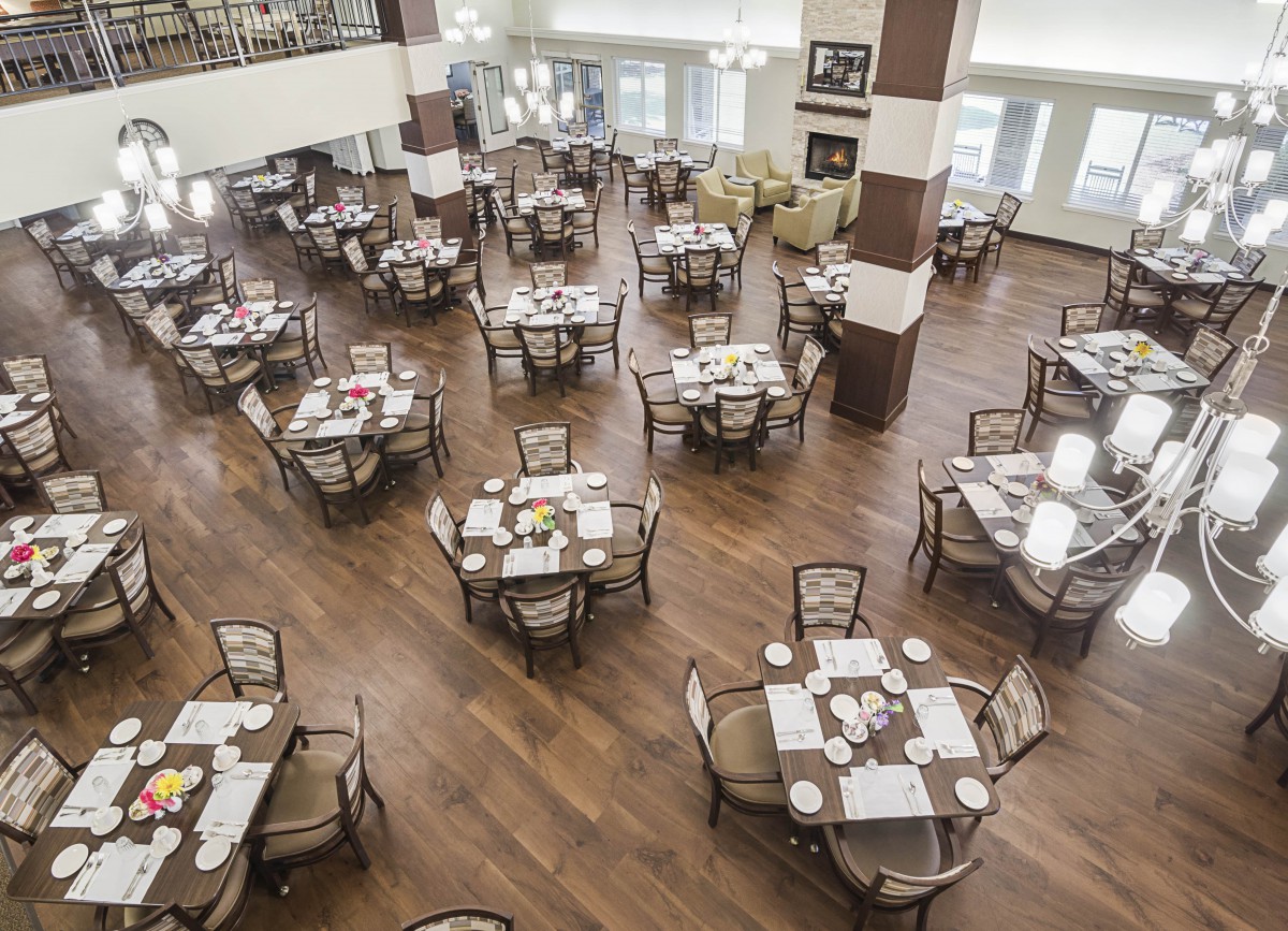 An empty dining area with neatly arranged tables and chairs, ready for guests.