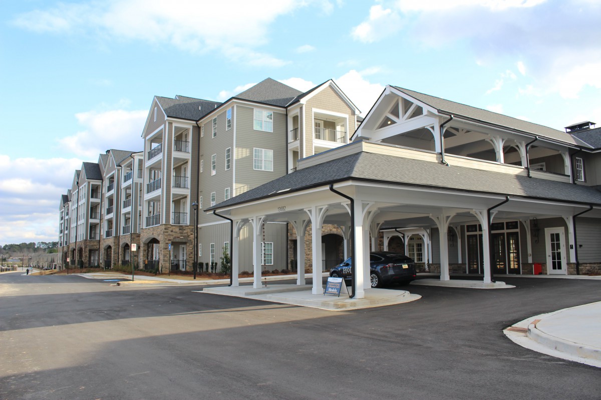 Modern hotel exterior with a covered entrance and multi-story design.