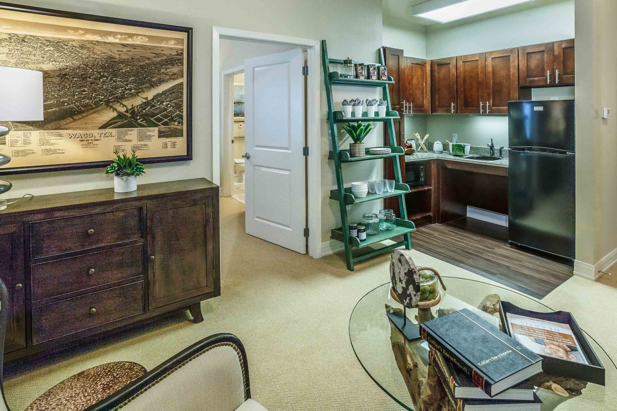 A cozy apartment interior featuring a kitchen and living area with modern decor.