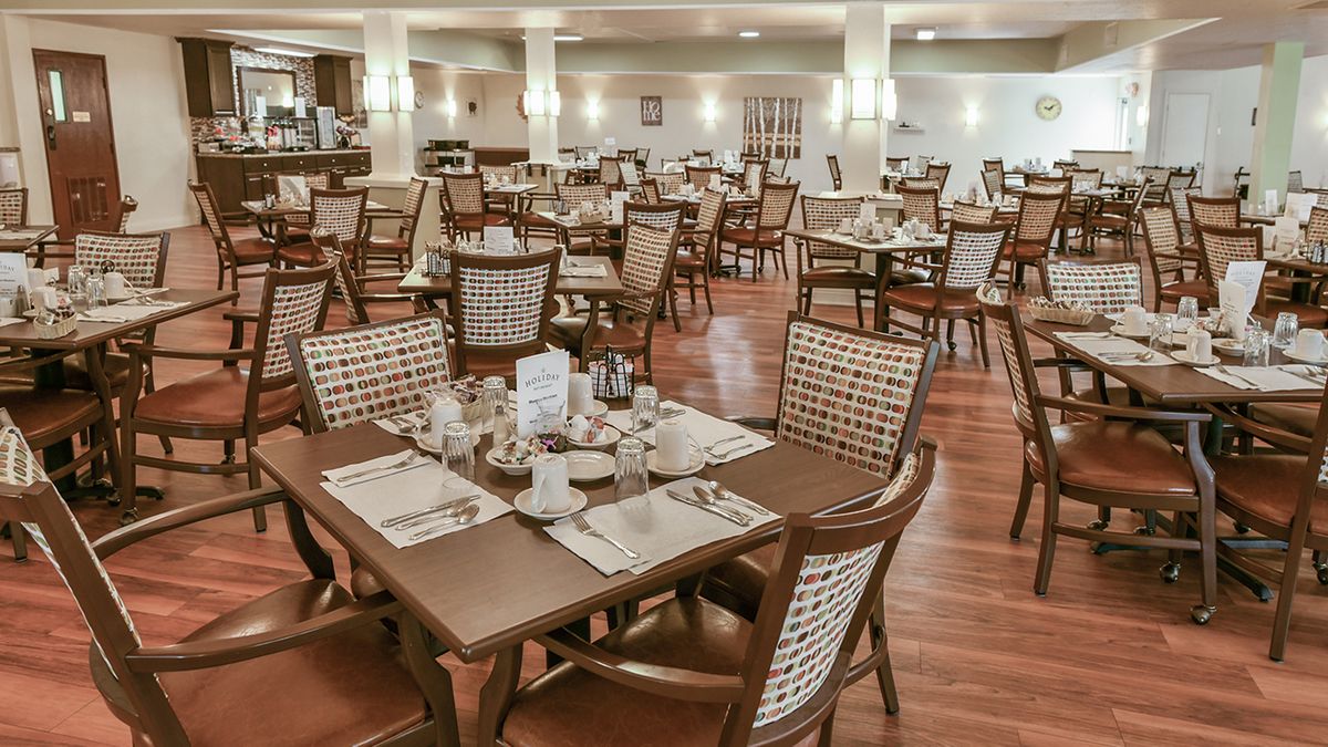 Empty restaurant dining area with neatly arranged tables and chairs.