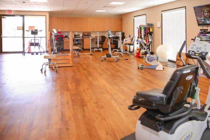 A well-equipped gym with various exercise machines and a spacious workout area.
